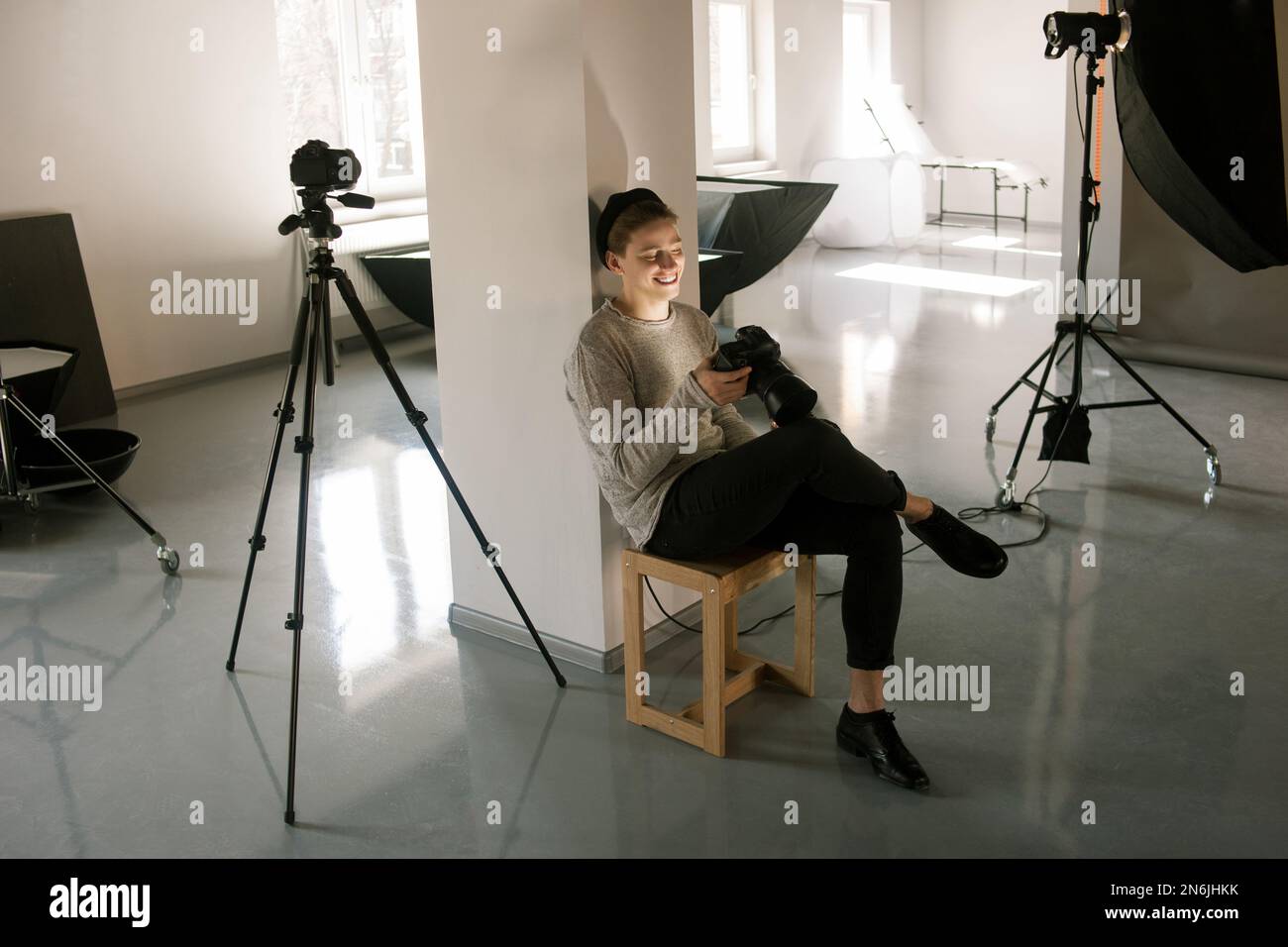 Photographer in studio enjoy pictures on camera Stock Photo