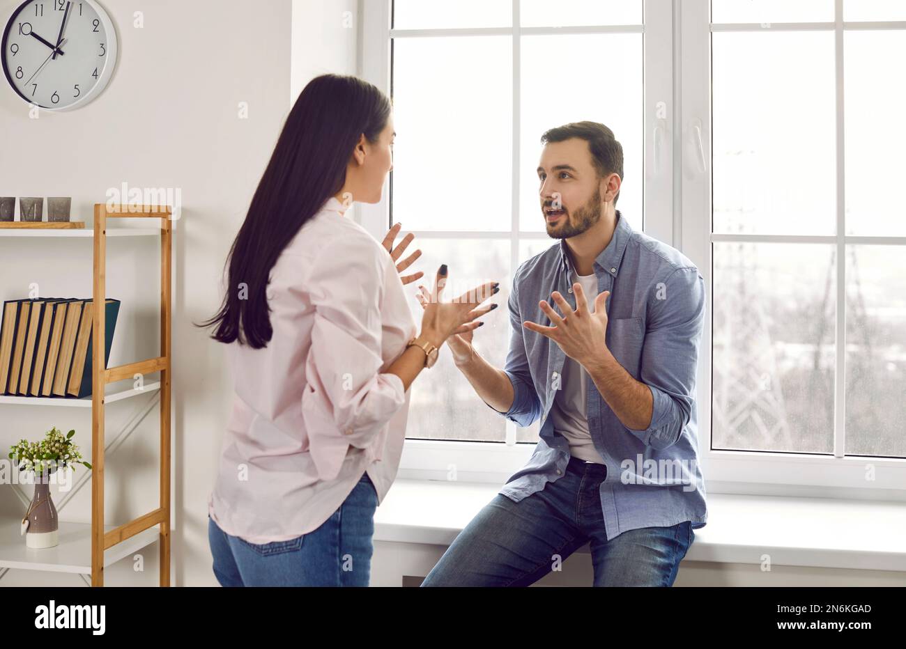 Young family couple having a disagreement, quarreling, and shouting at each other Stock Photo