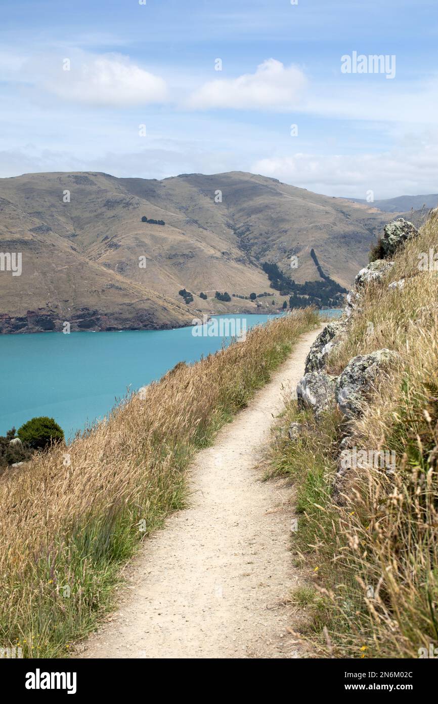 A path with a sea view. A road for hiking with a stunning landscape. Landscape. Stock Photo