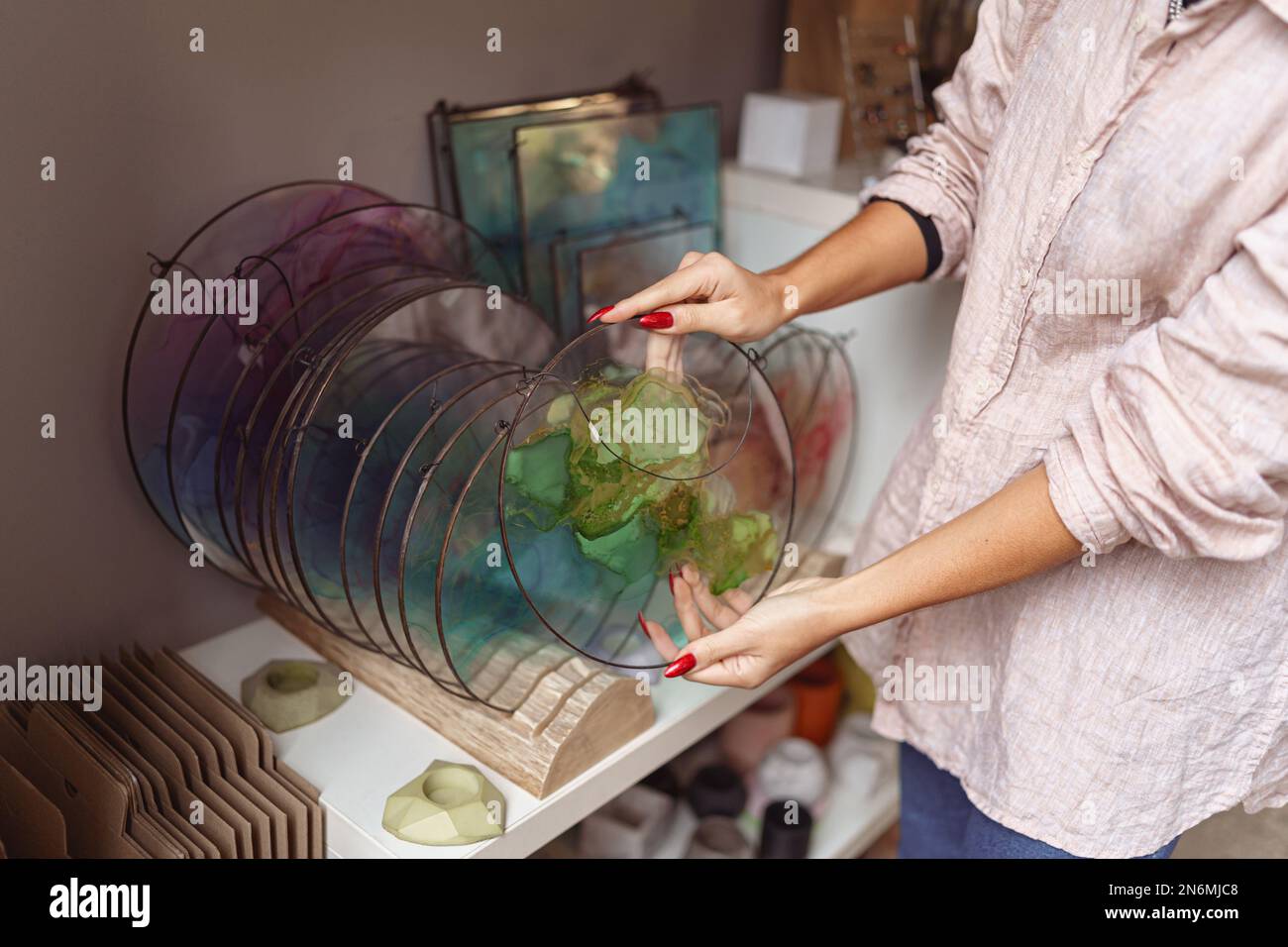 Female decorator hands place handmade epoxy resin tray on stand exposition Stock Photo Alamy
