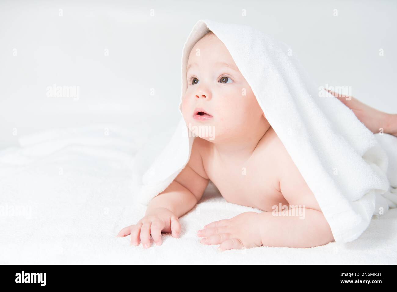 Happy little baby in white towels after bath Stock Photo