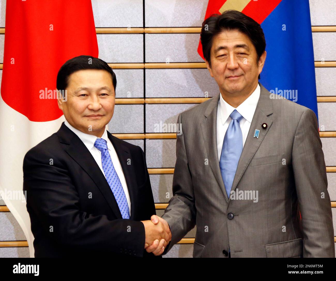 Japanese Prime Minister Shinzo Abe, right, shakes hands with Mongolian ...