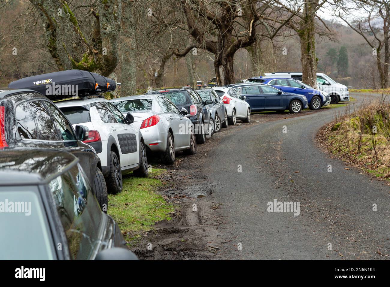 Hill walkers cars parked on the verges of a single track road at the start of Ben Vorlich on Loch Earn, Perthshire. Stock Photo
