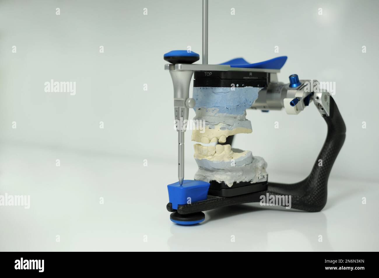 An articulator used in dental laboratories clipped on white background dental articulator with