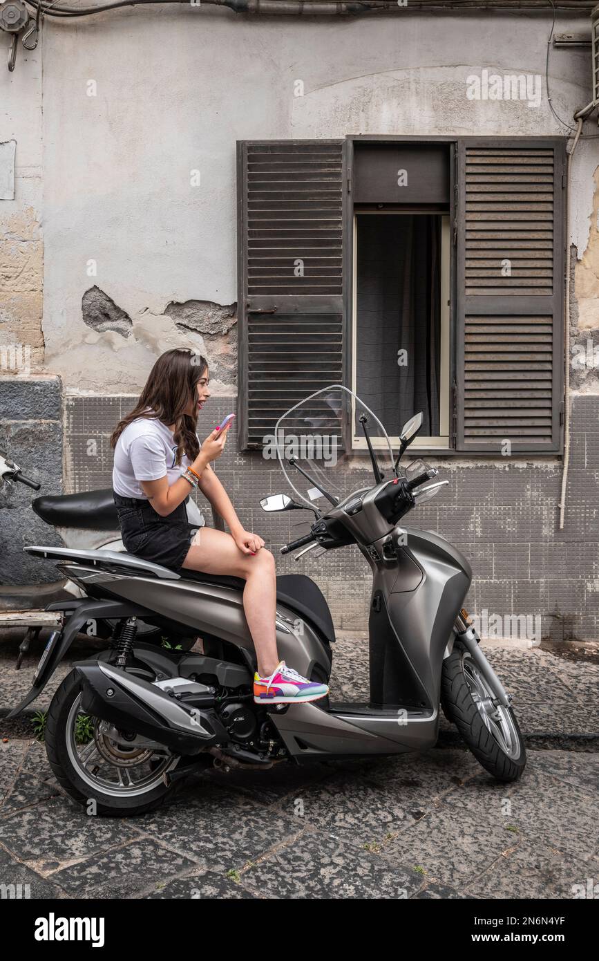 Premium Photo  Seductive sicilian woman sitting on a step in an old town  in sicily
