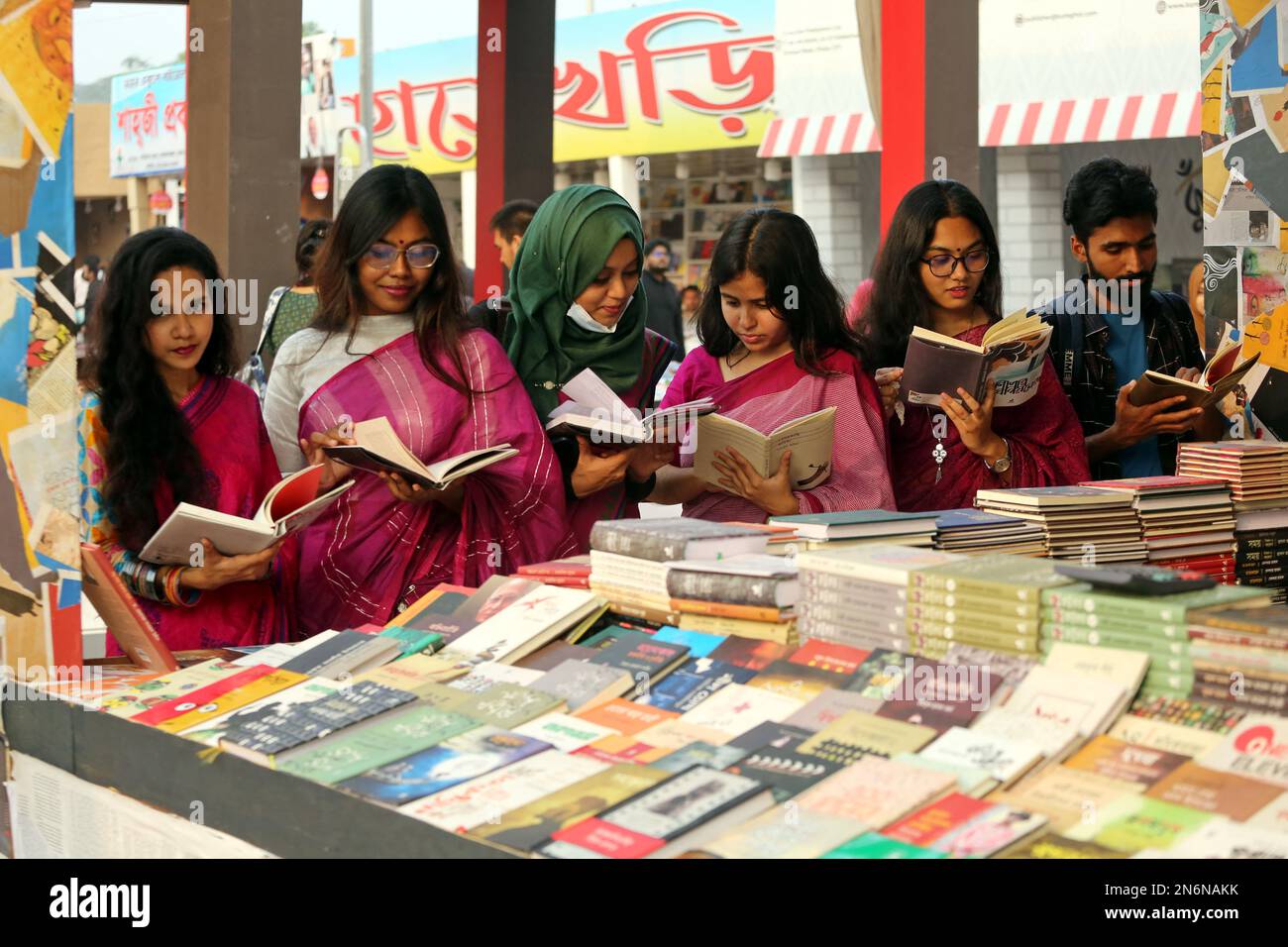 Dhaka, Bangladesh, February 9, 2023. Visitors read books at the