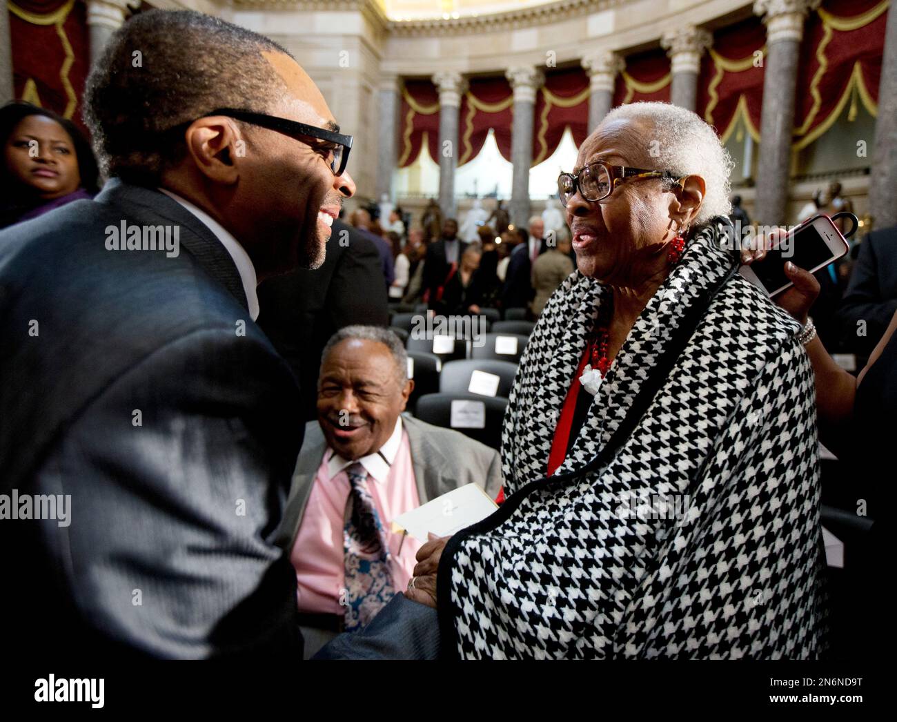 Film maker Spike Lee, left, greets Maxine McNair, right, and Jewell