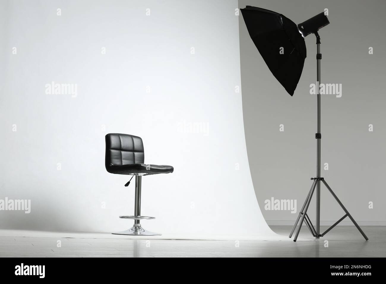 Modern chair and professional lighting equipment in photo studio Stock Photo