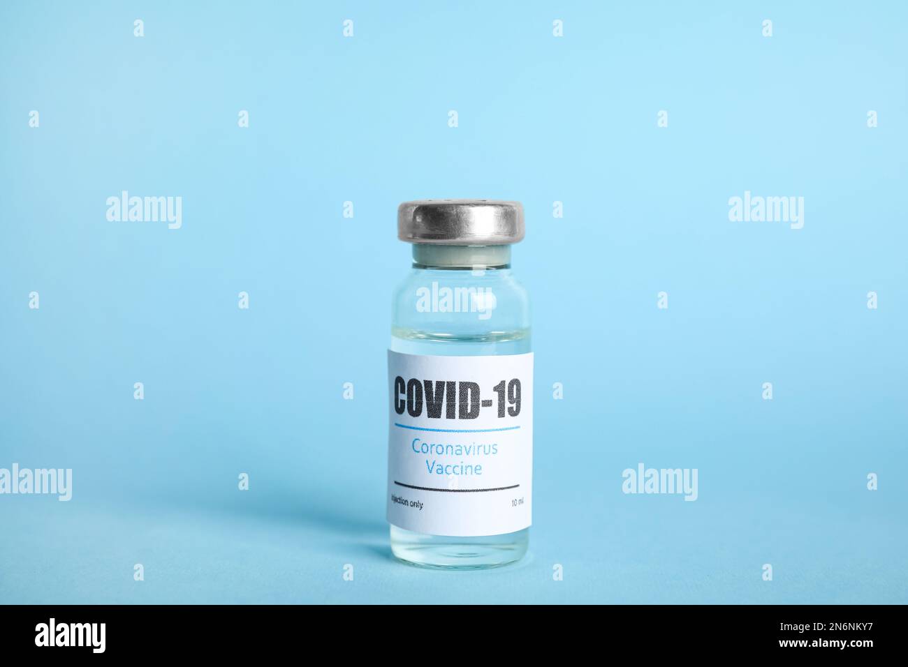 Vial with coronavirus vaccine on light blue background Stock Photo - Alamy