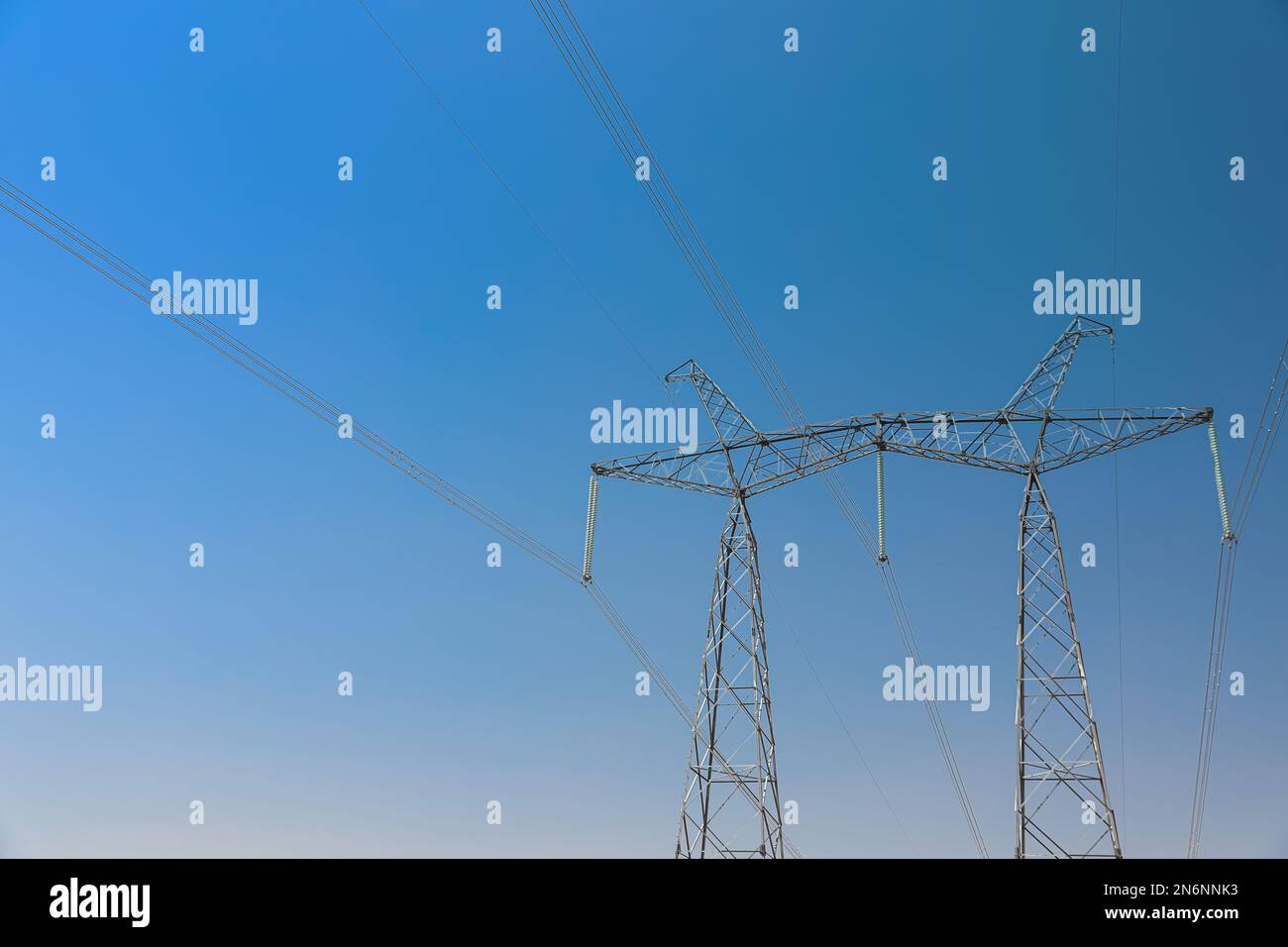 High voltage tower with electricity transmission power lines against ...