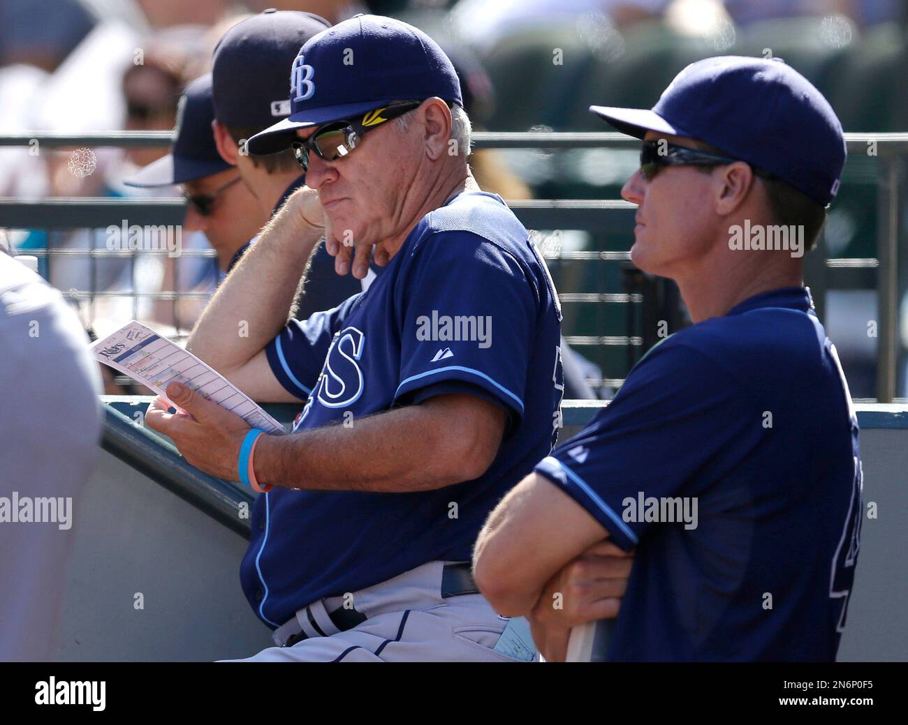 Tampa Bay Rays manager Joe Maddon, left, looks at his lineup card as he