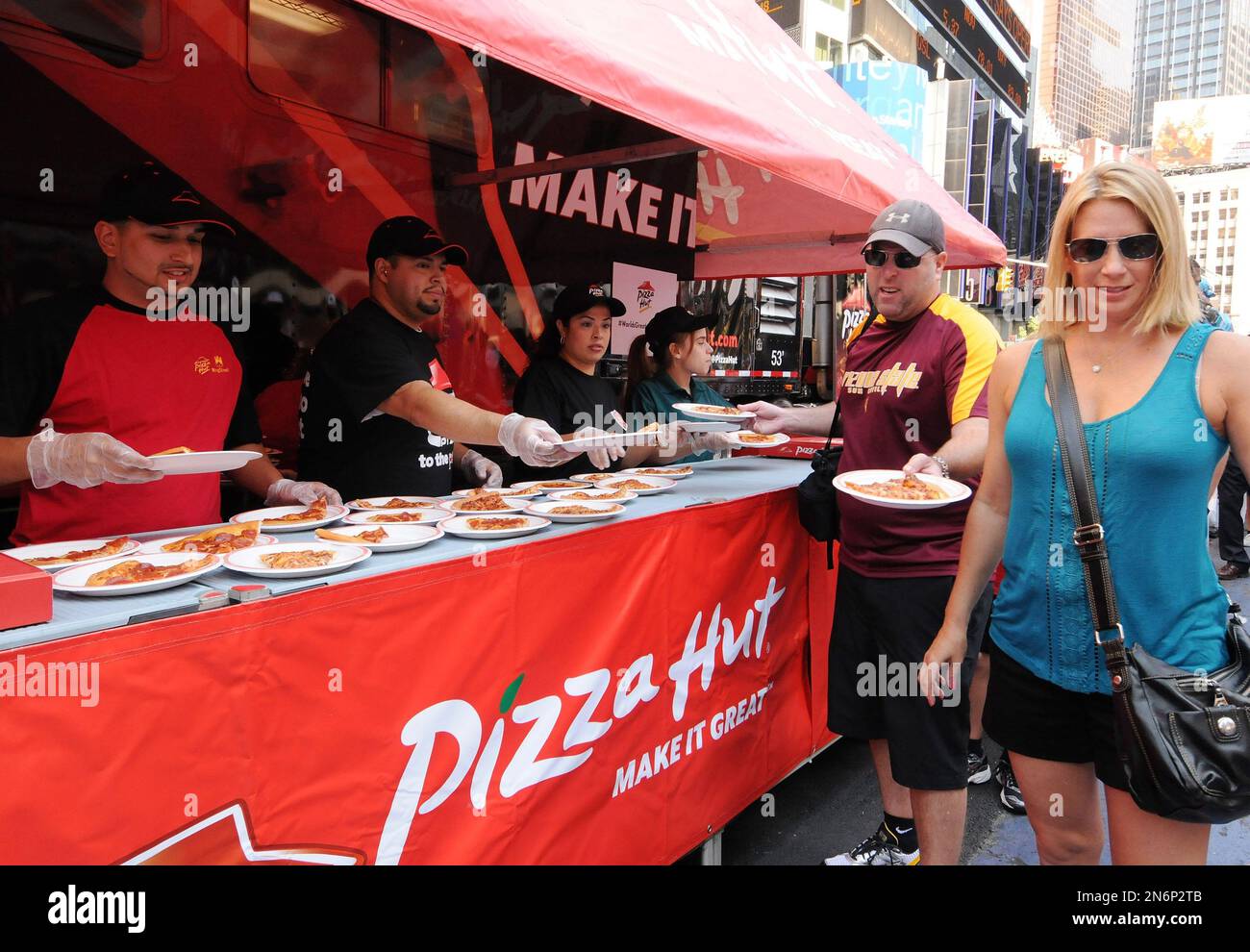 Fans enjoy Pizza Hut pizza in Times Square during The World's Greatest