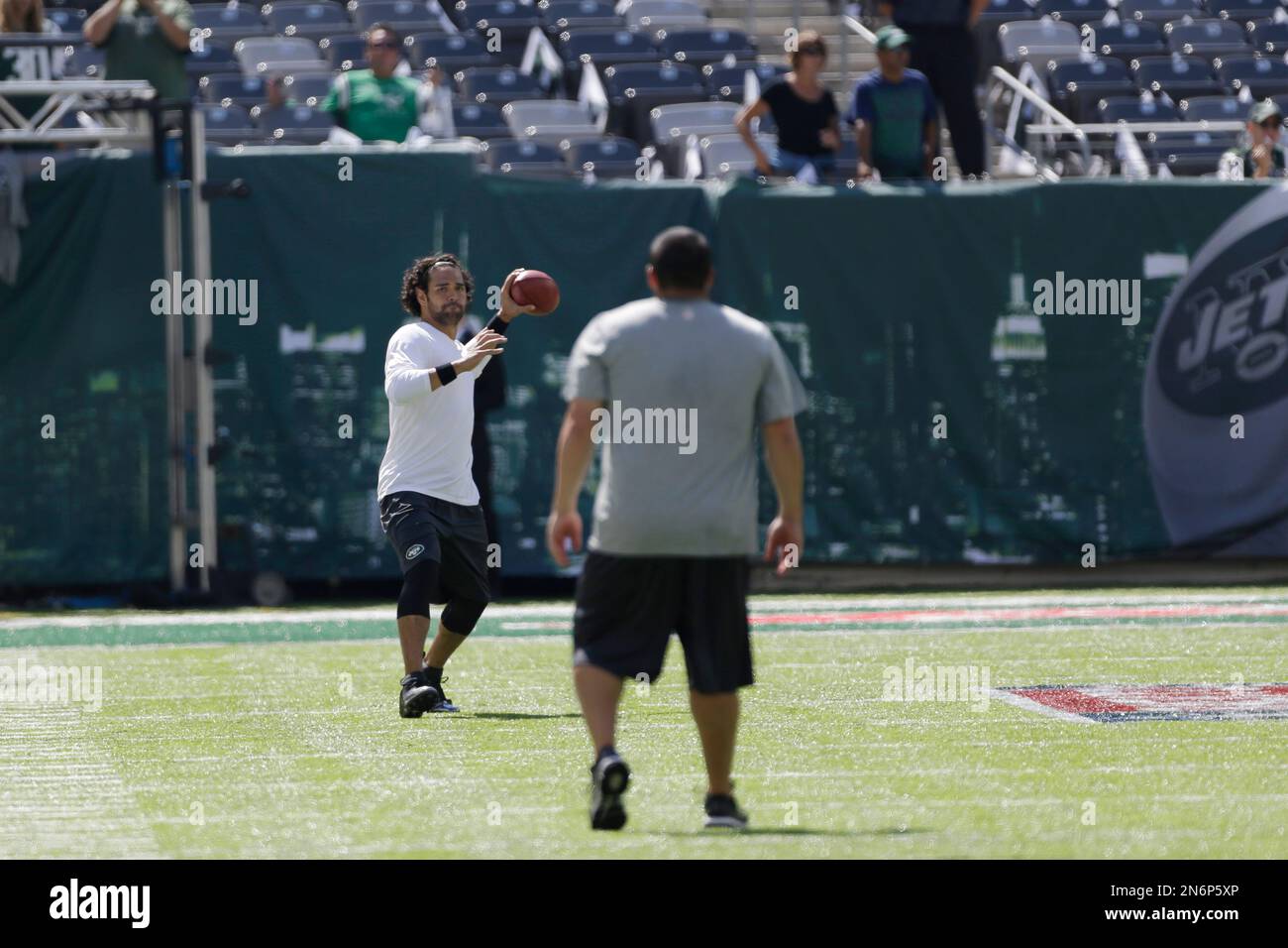 New York Jets quarterback Mark Sanchez, left, throws a left handed pass