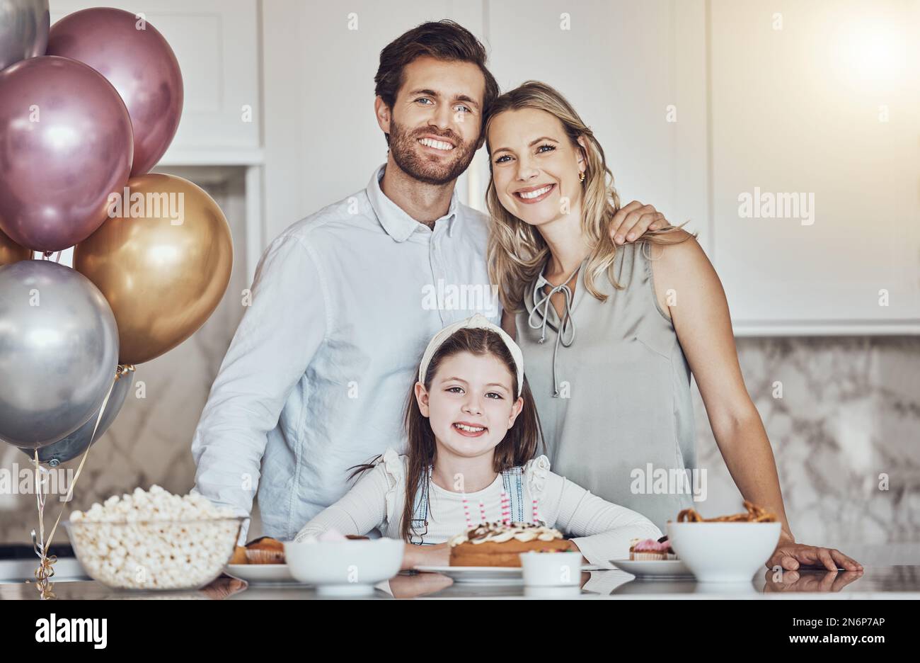 Portrait, family or girl in celebration of a happy birthday in a house party or kitchen with a smile popcorn or cake. Mother, dad or child bonding or Stock Photo