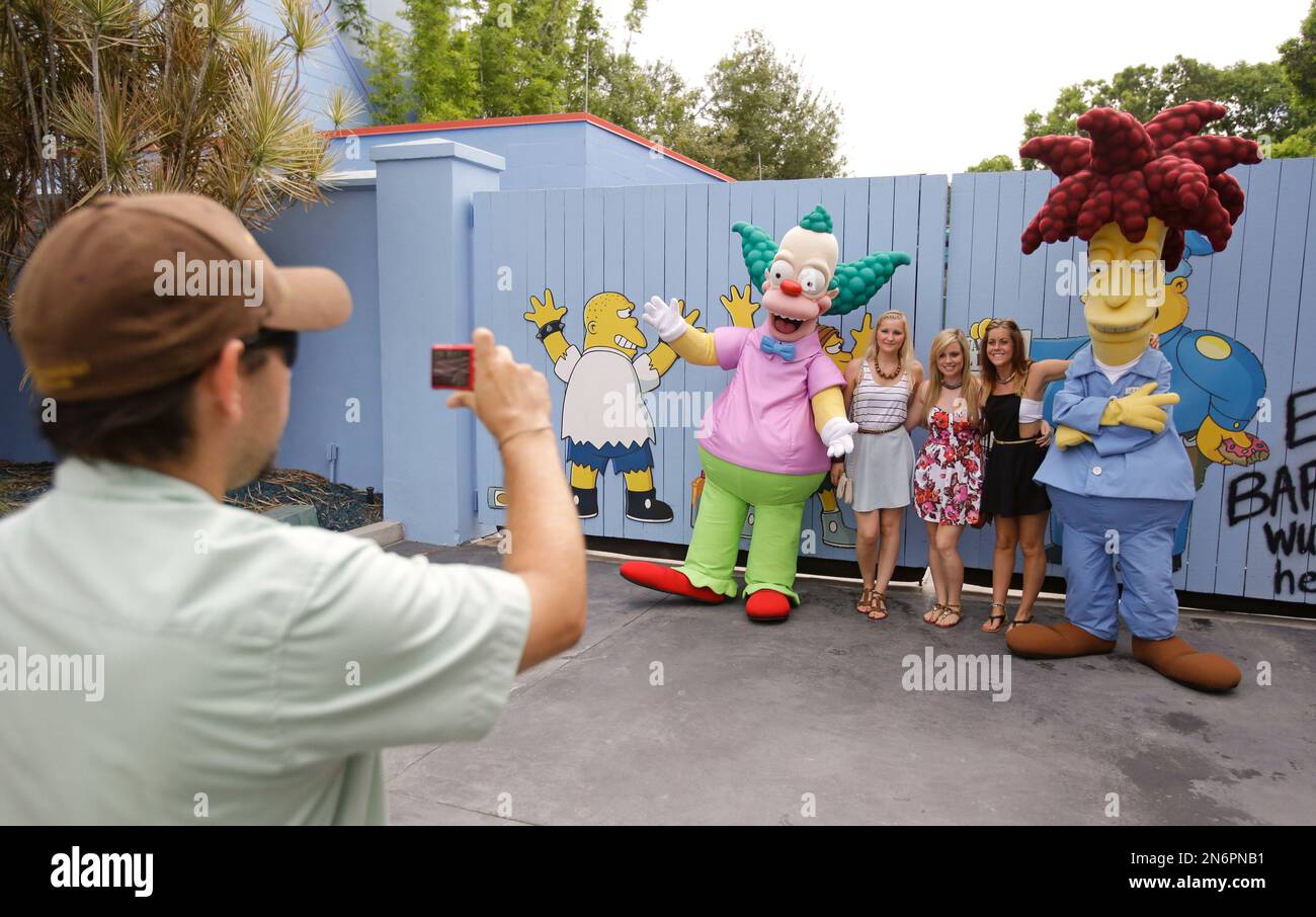 This Sept. 5, 2013 photo shows a park employee taking a photo of guests ...