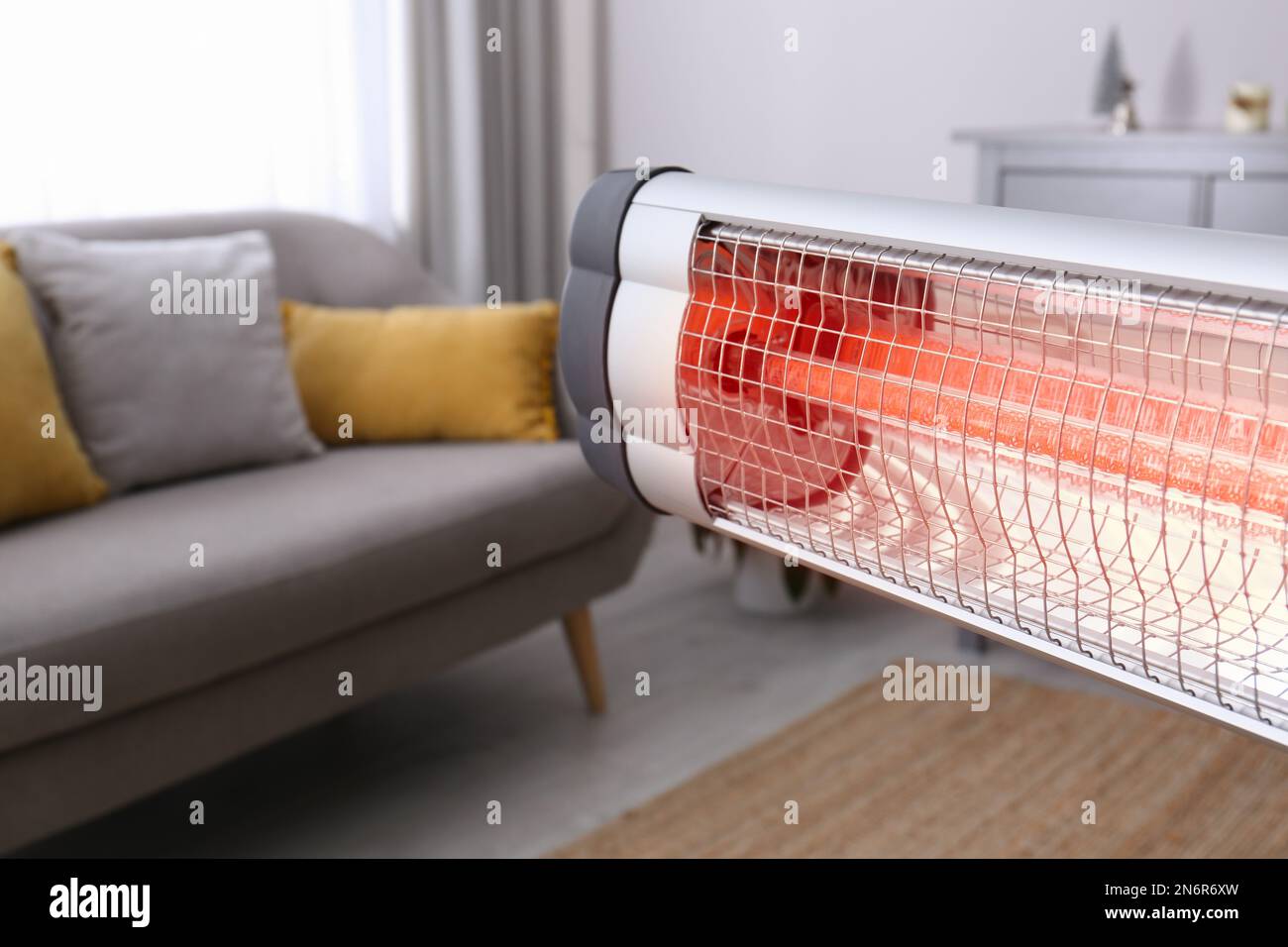 Modern electric infrared heater in room, closeup. Space for text Stock