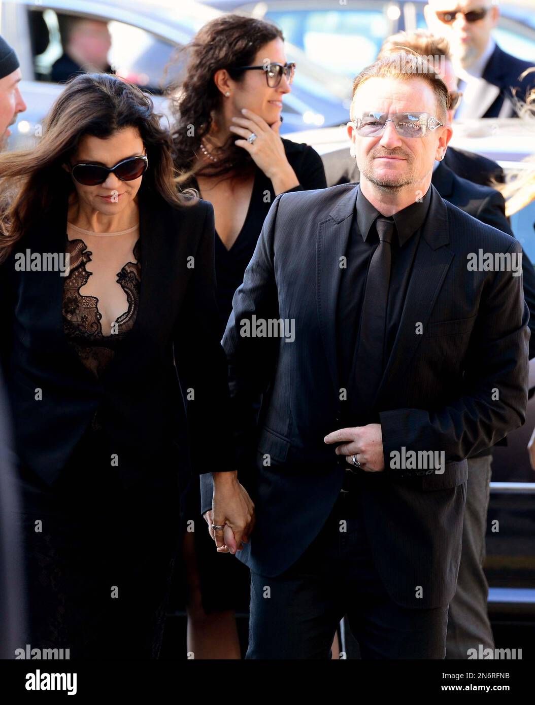U2 singer Bono, right arrives with his wife Ali Hewson for the funeral