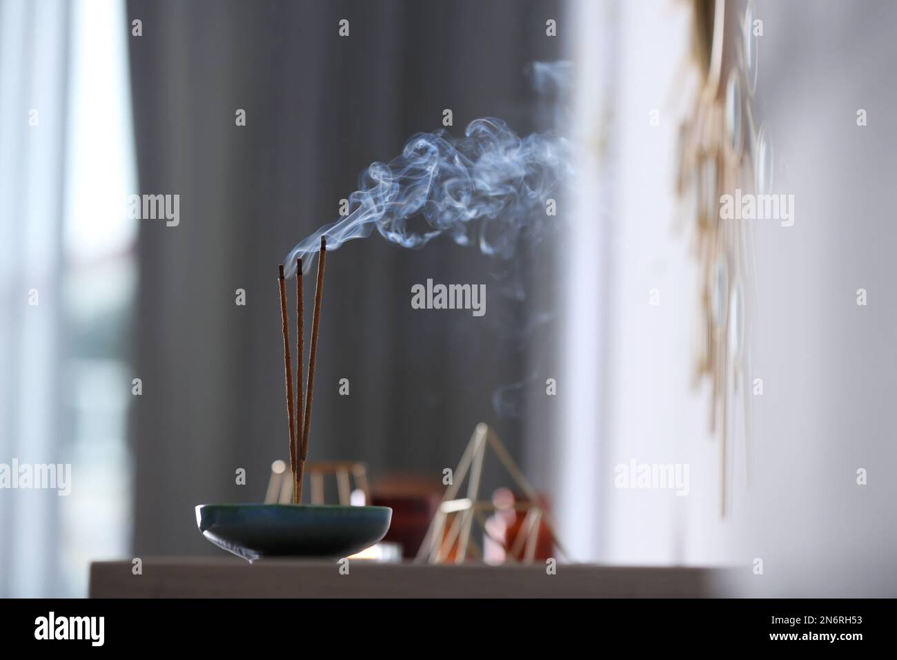 Incense sticks smoldering on table indoors, space for text Stock Photo ...