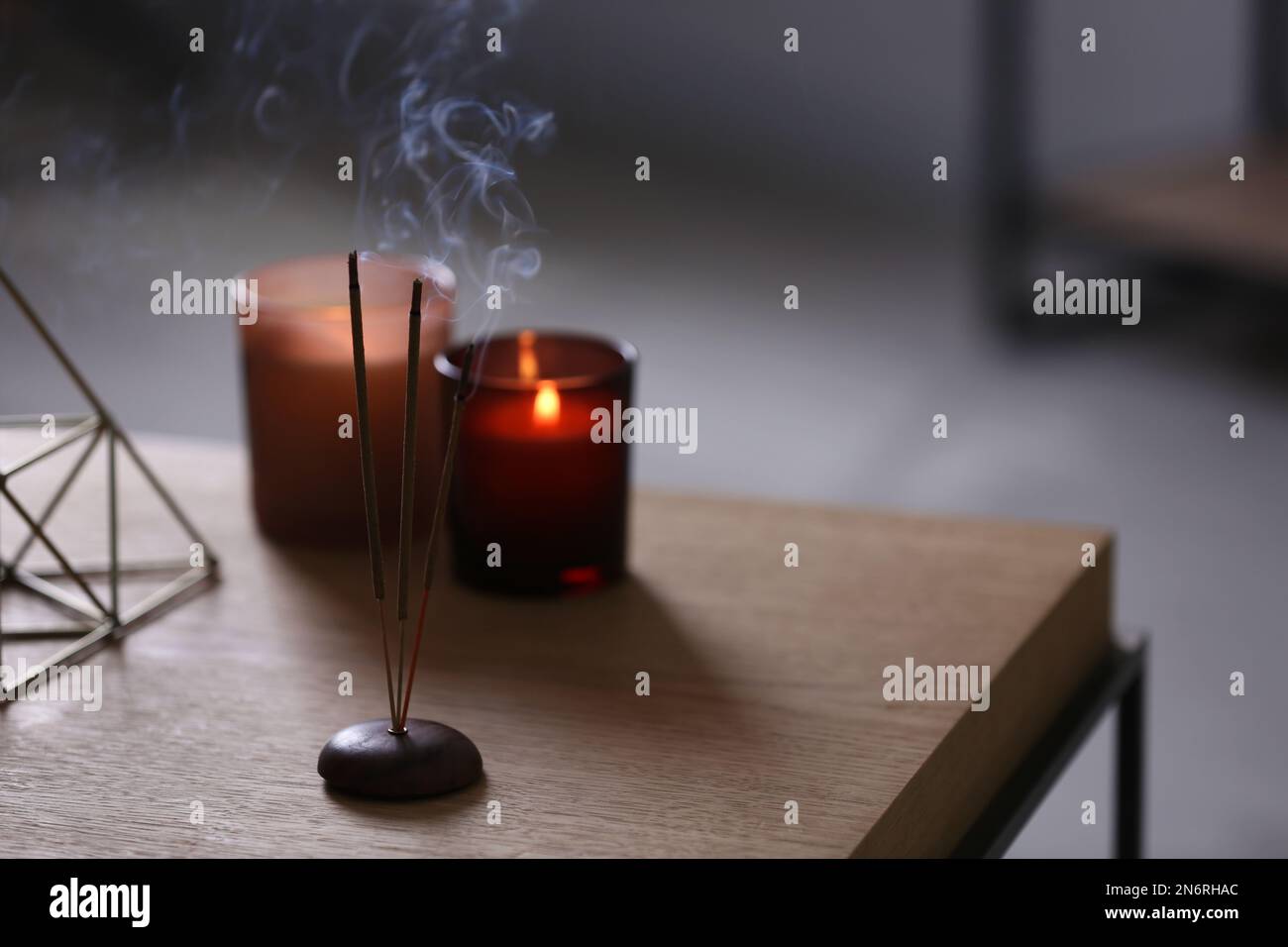 Incense sticks smoldering on table indoors, space for text Stock Photo ...