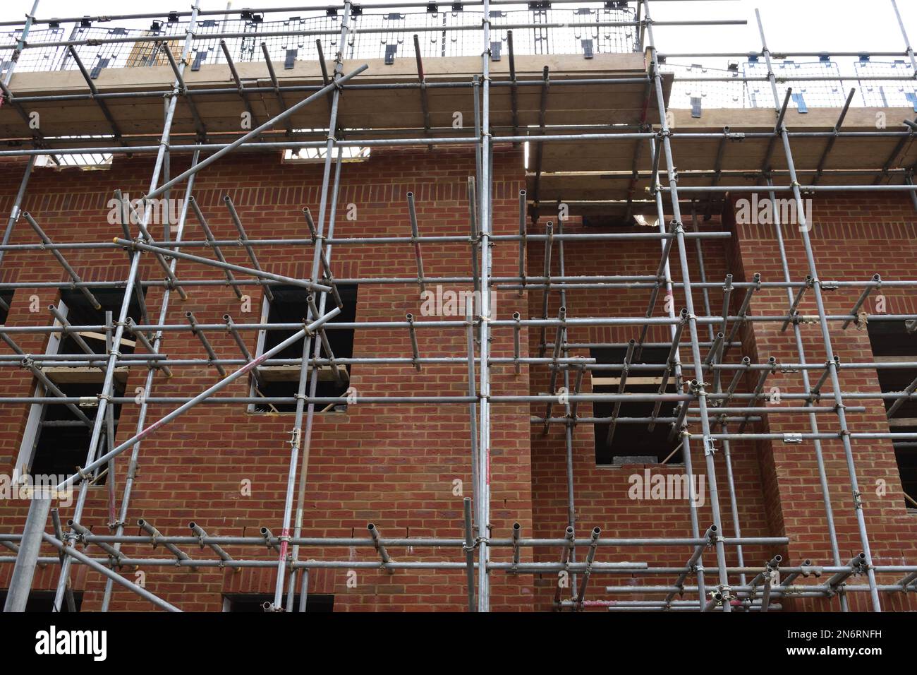 construction of brick building flats with scaffolding Stock Photo - Alamy