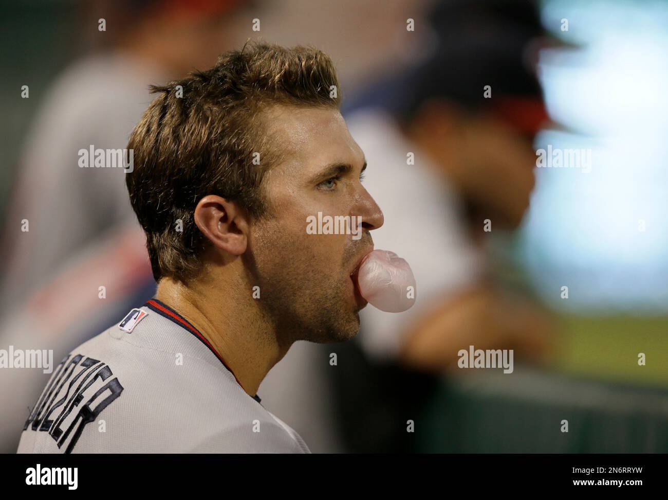 Minnesota Twins' Brian Dozier blows a bubble out of chewing gum as