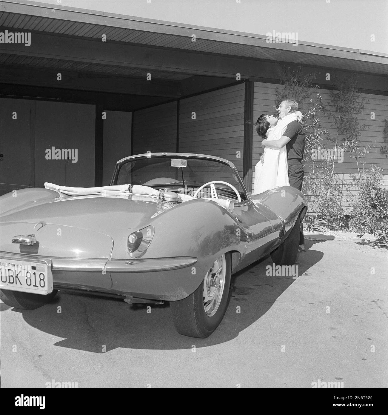 Actor Steve McQueen and his wife Neile pose with one of his Jaguar(03)