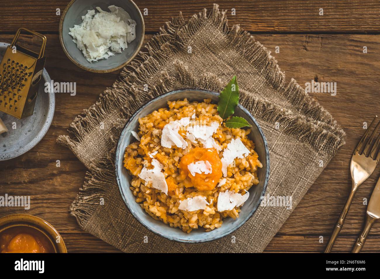Homemade pumpkin risotto with parmesan cheese on a rustic wooden table, top view Stock Photo