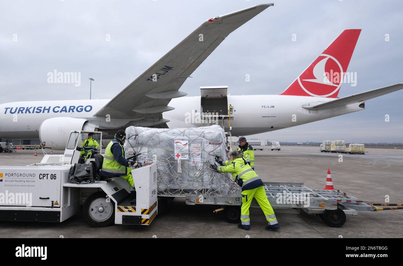 Schkeuditz, Germany. 10th Feb, 2023. Ground staff work on a trailer with relief supplies at Leipzig-Halle Airport. The German Red Cross (DRK) plans to send an aid transport from Leipzig Airport to the earthquake region of Turkey and Syria on Feb. 10, 2023. Credit: Sebastian Willnow/dpa/Alamy Live News Stock Photo