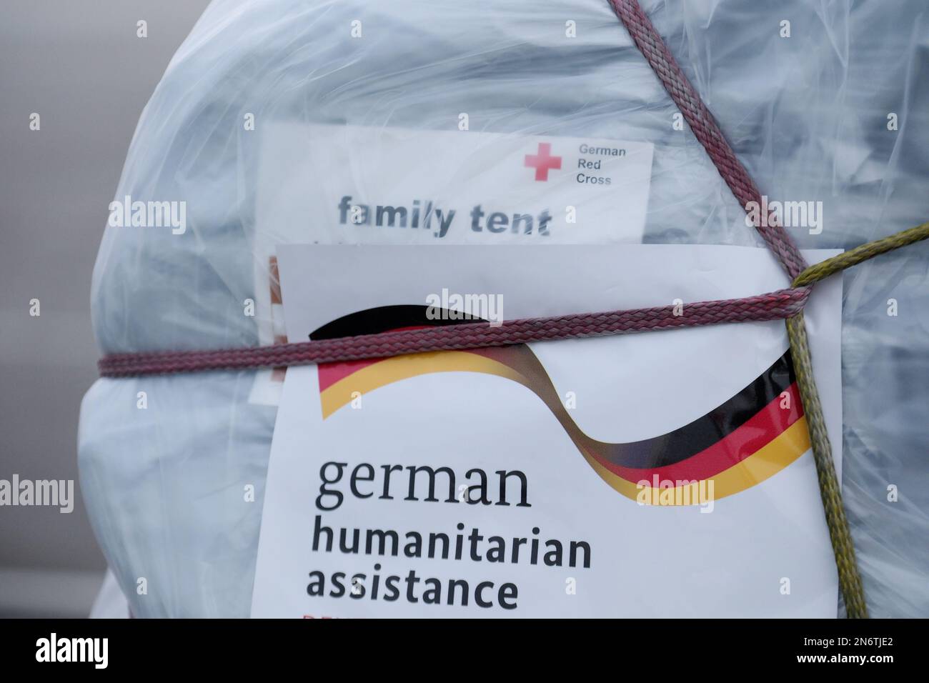 Schkeuditz, Germany. 10th Feb, 2023. A label with the words 'family tent' is attached to relief supplies at Leipzig-Halle Airport. The German Red Cross (DRK) plans to send an aid transport from Leipzig Airport to the earthquake region of Turkey and Syria on Feb. 10, 2023. Credit: Sebastian Willnow/dpa/Alamy Live News Stock Photo