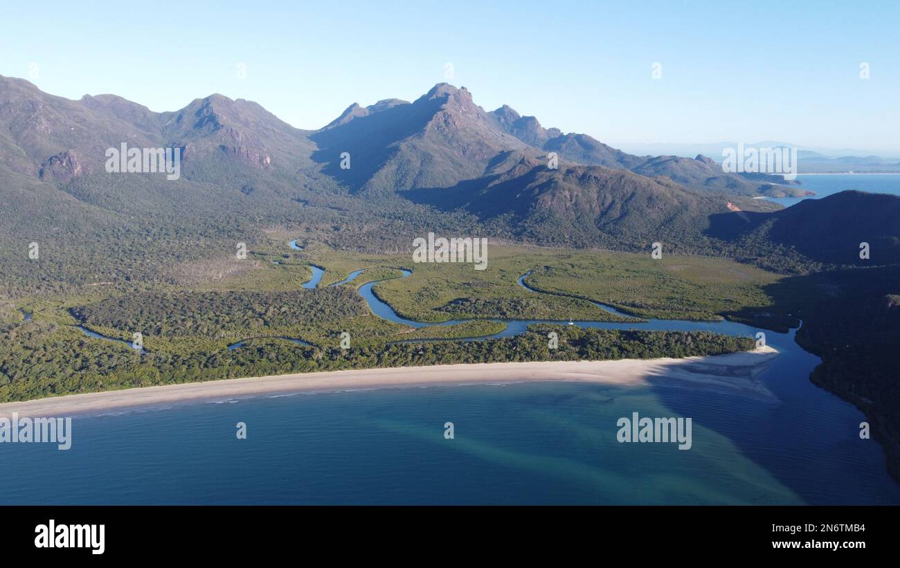 Aerial shot of Zoe Bay with the mangroves and mountains of Hinchinbrook
