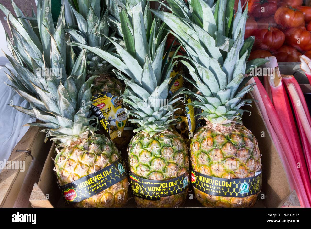 Del Monte Honeyglow pineapples in a box outside a greengrocers Stock