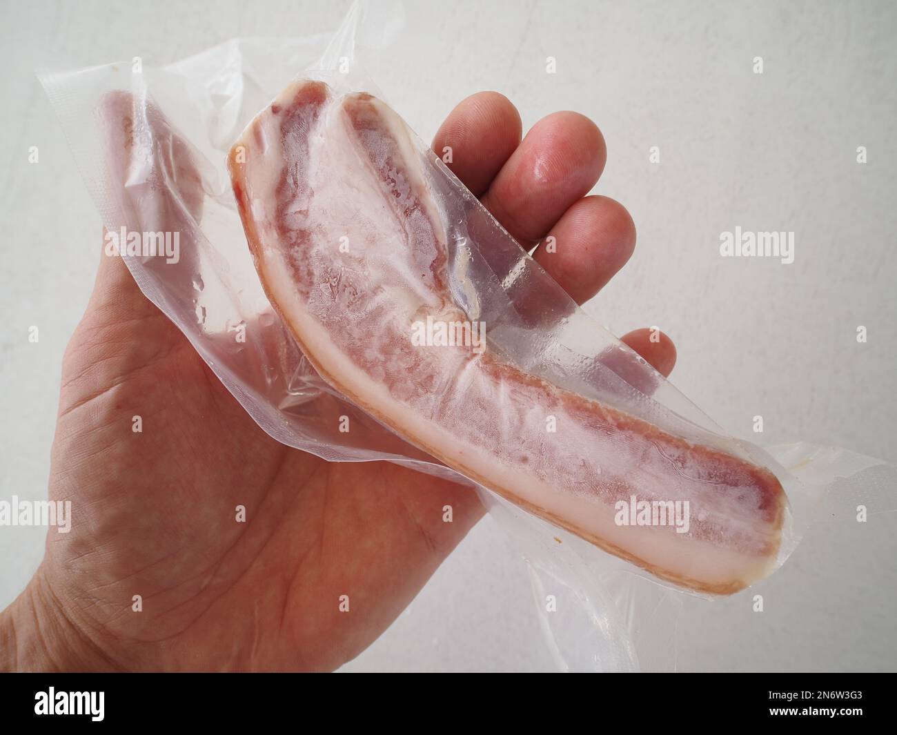 Pack with lard in hand Stock Photo - Alamy