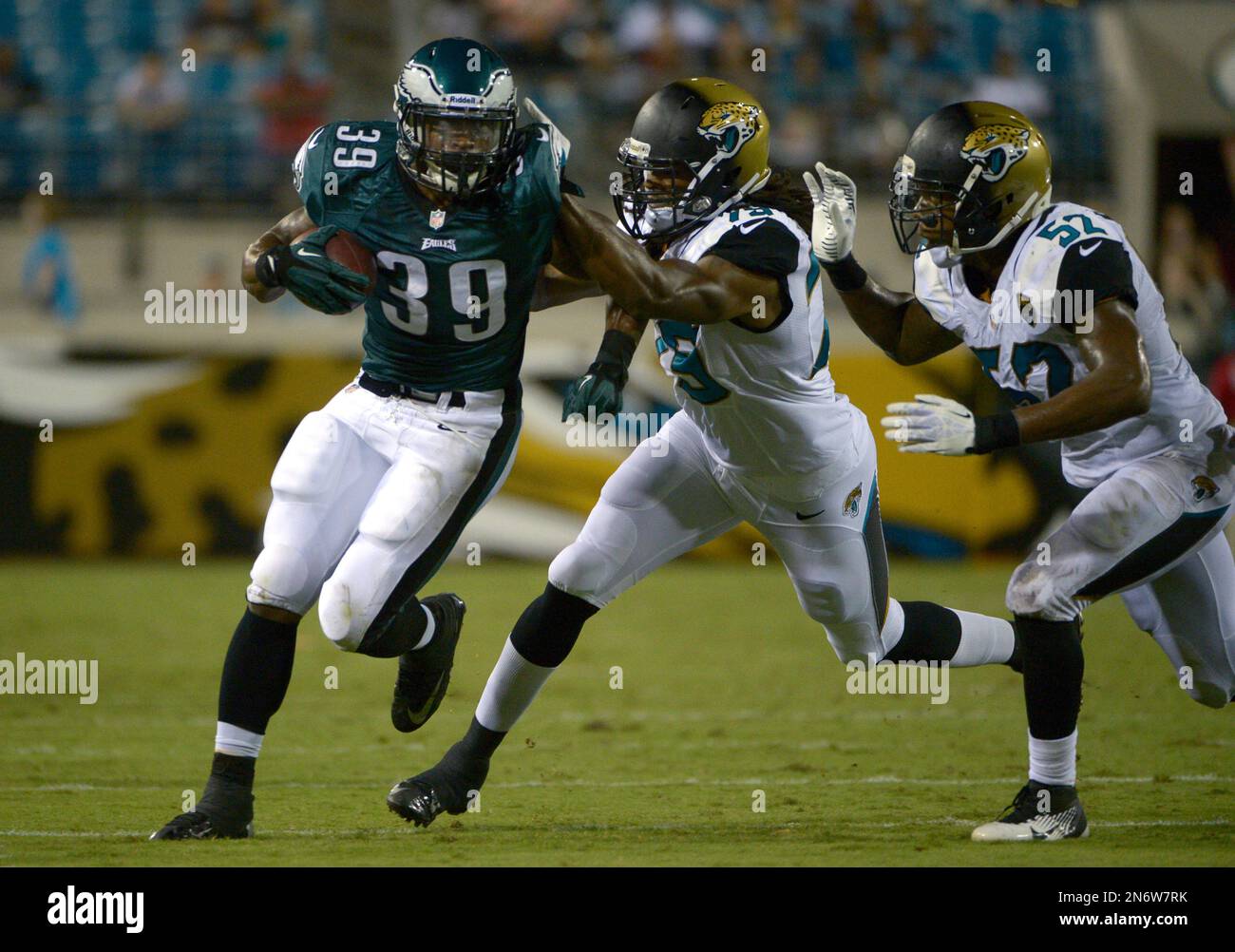 Philadelphia Eagles running back Matthew Tucker (39) runs past Jacksonville  Jaguars defensive end Paul Hazel (79), center, and Jacksonville Jaguars  linebacker Brandon Marshall (52) during the second half of an NFL preseason