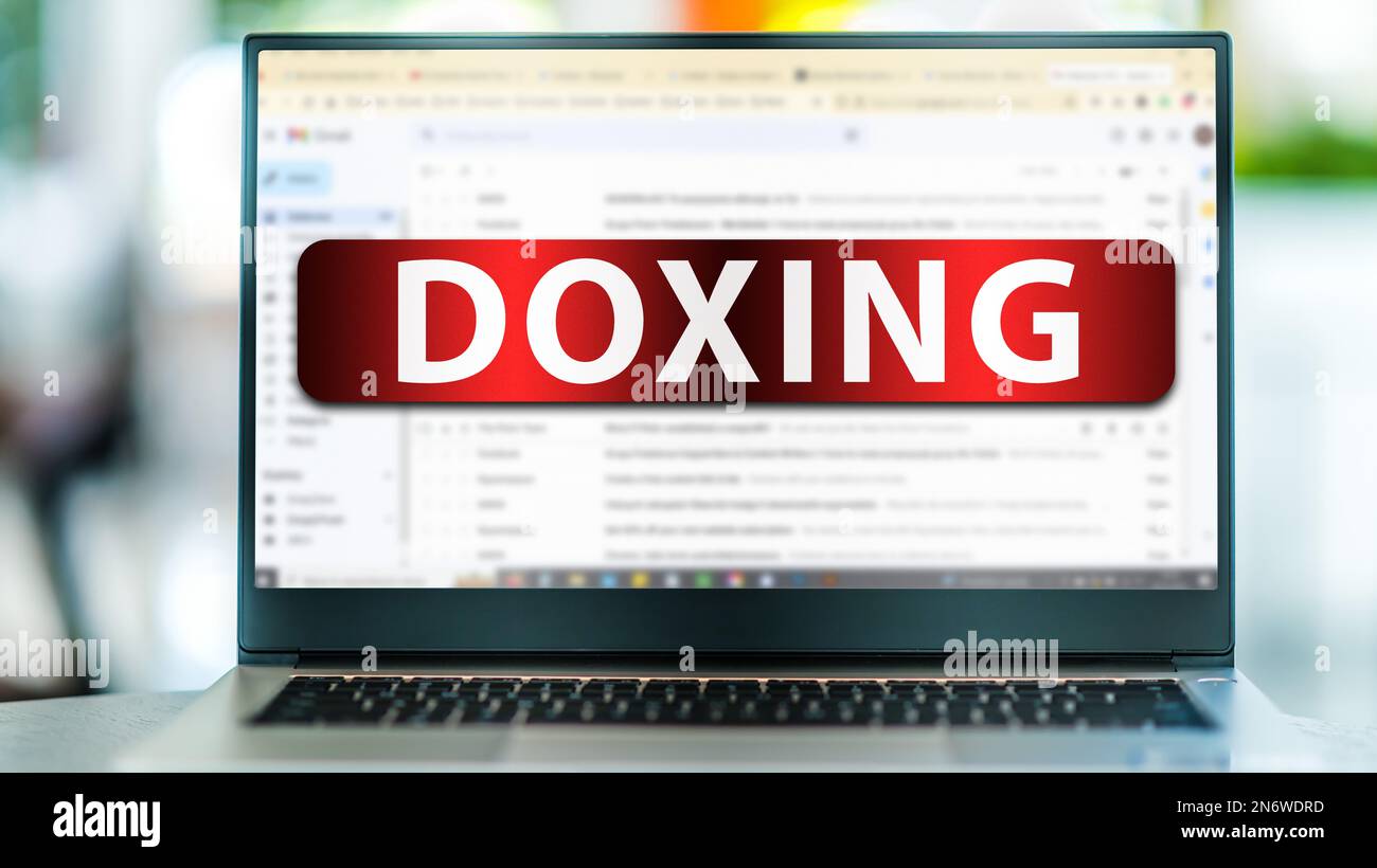 Laptop computer displaying the sign of doxing on an internet email site ...