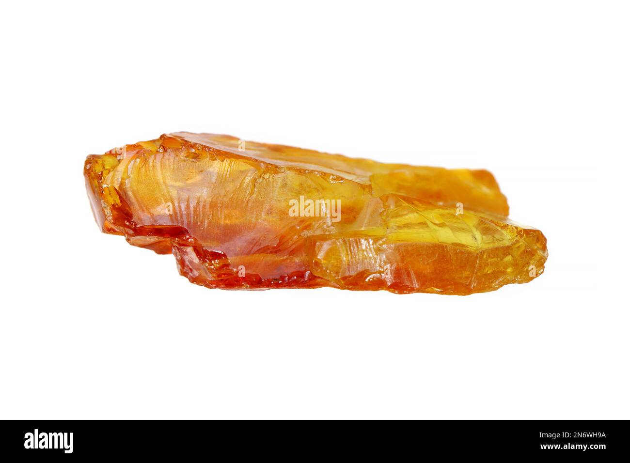 Closeup natural rough uncut amber stone on white background. Amber is a fossilized tree resin. Stock Photo