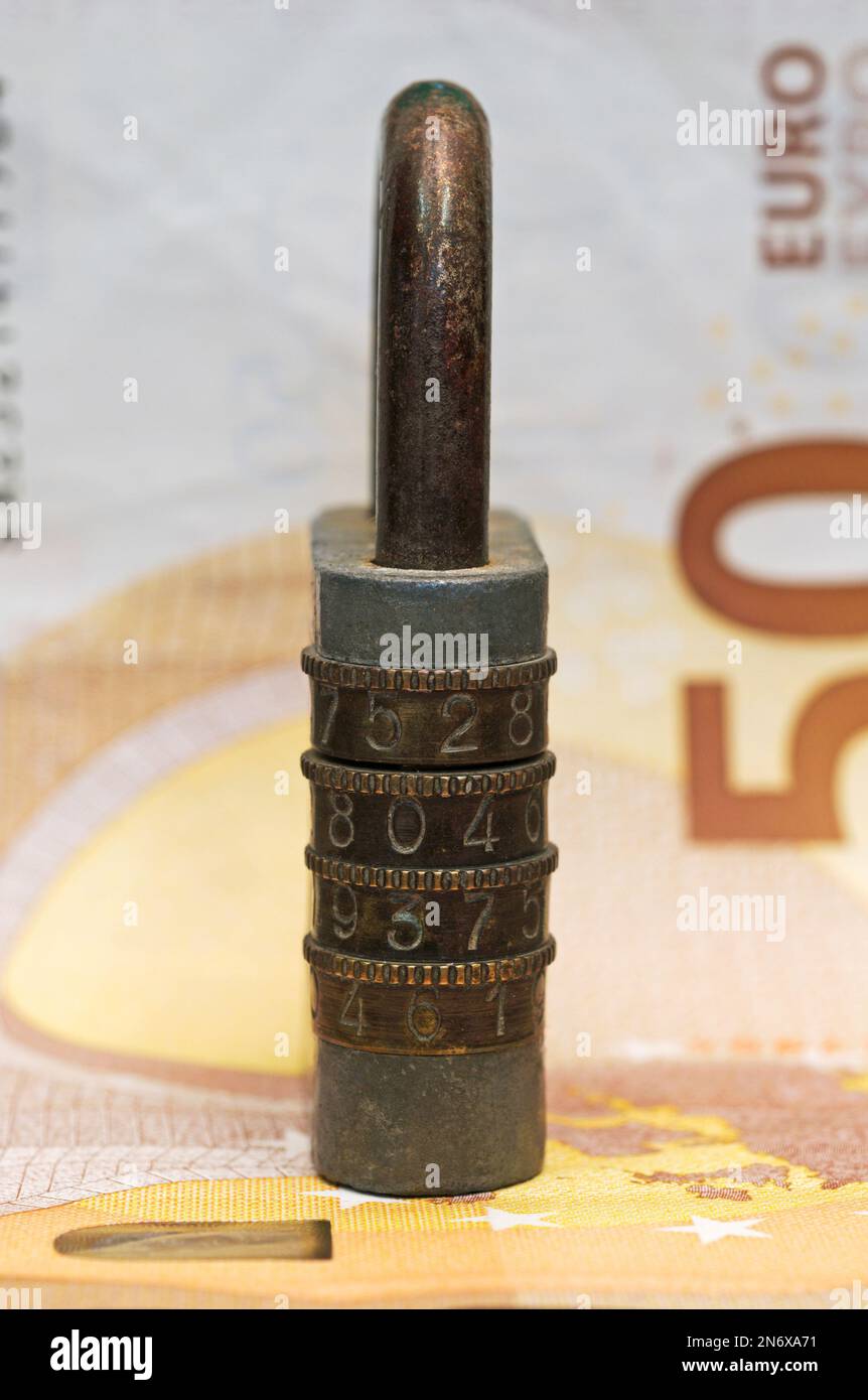 an old combination padlock over a 50 euro banknote Stock Photo