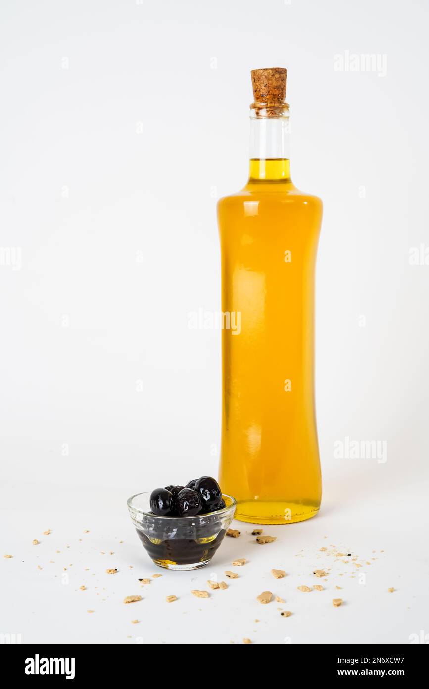 Glass bottle of olive oil and pickled black olives isolated on white background Stock Photo Alamy