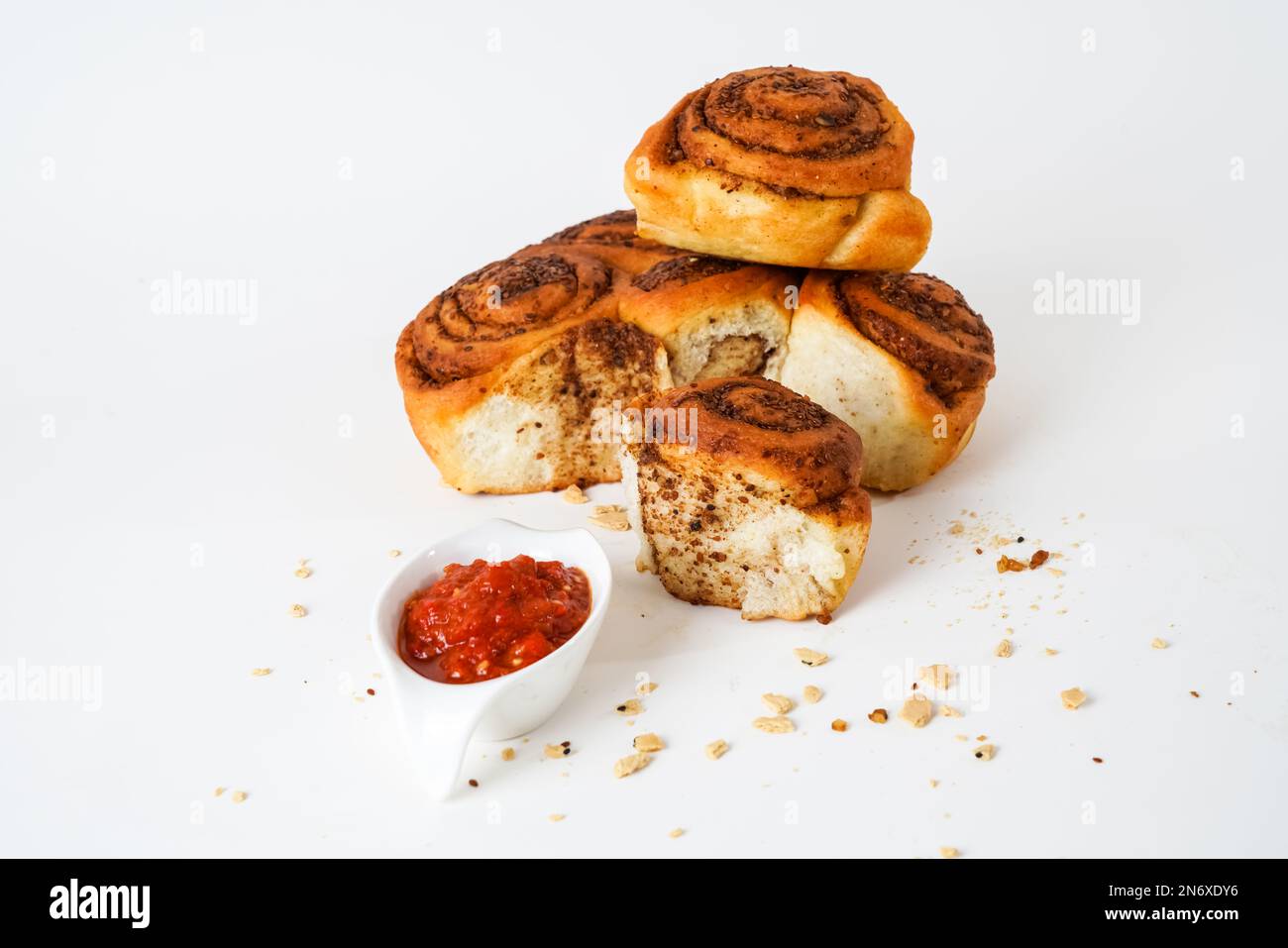 Salty bread with walnut poppy sesame and chili tomato sauce isolated on