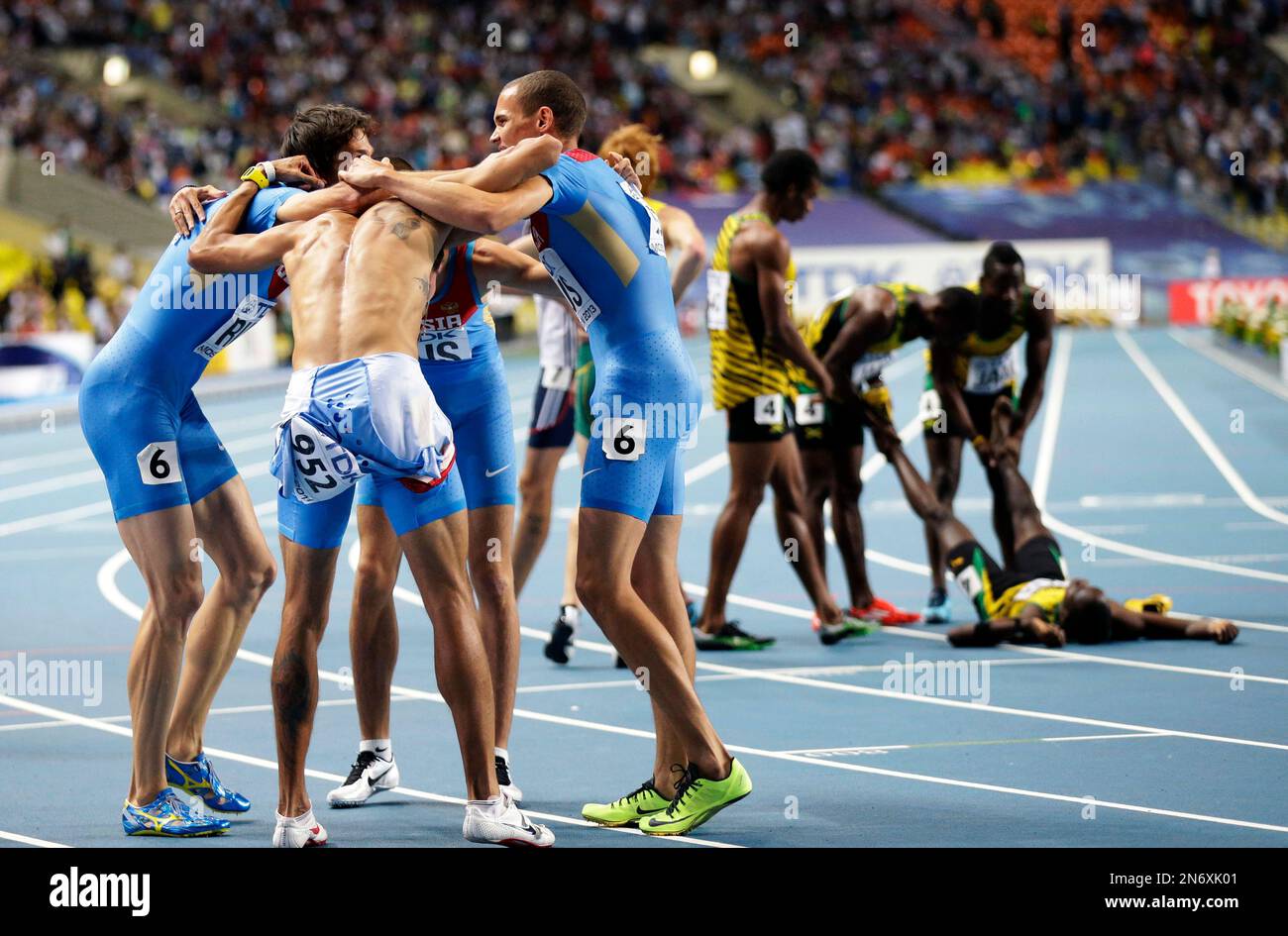 The Russian relay team, left, celebrate winning silver in the men's