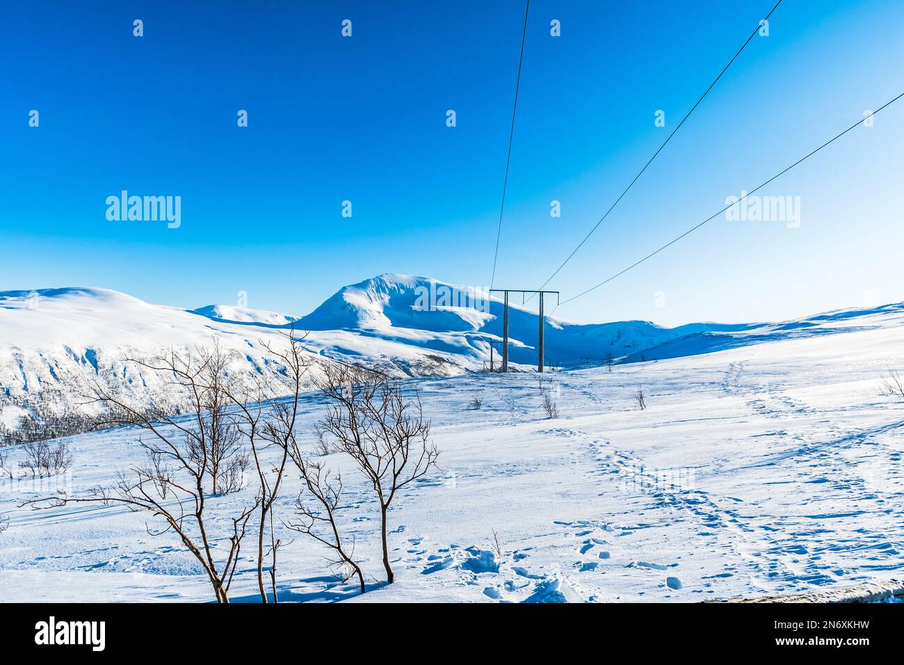 Snowy mountain and blue sky in Norway on a sunny winter day, copy space Stock Photo