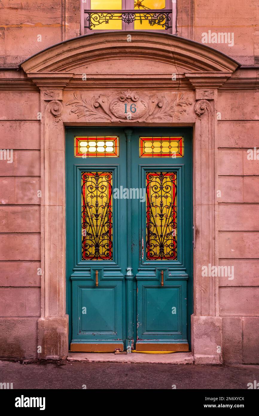 Old blue front door with colorful stained glass in Paris, France Stock Photo