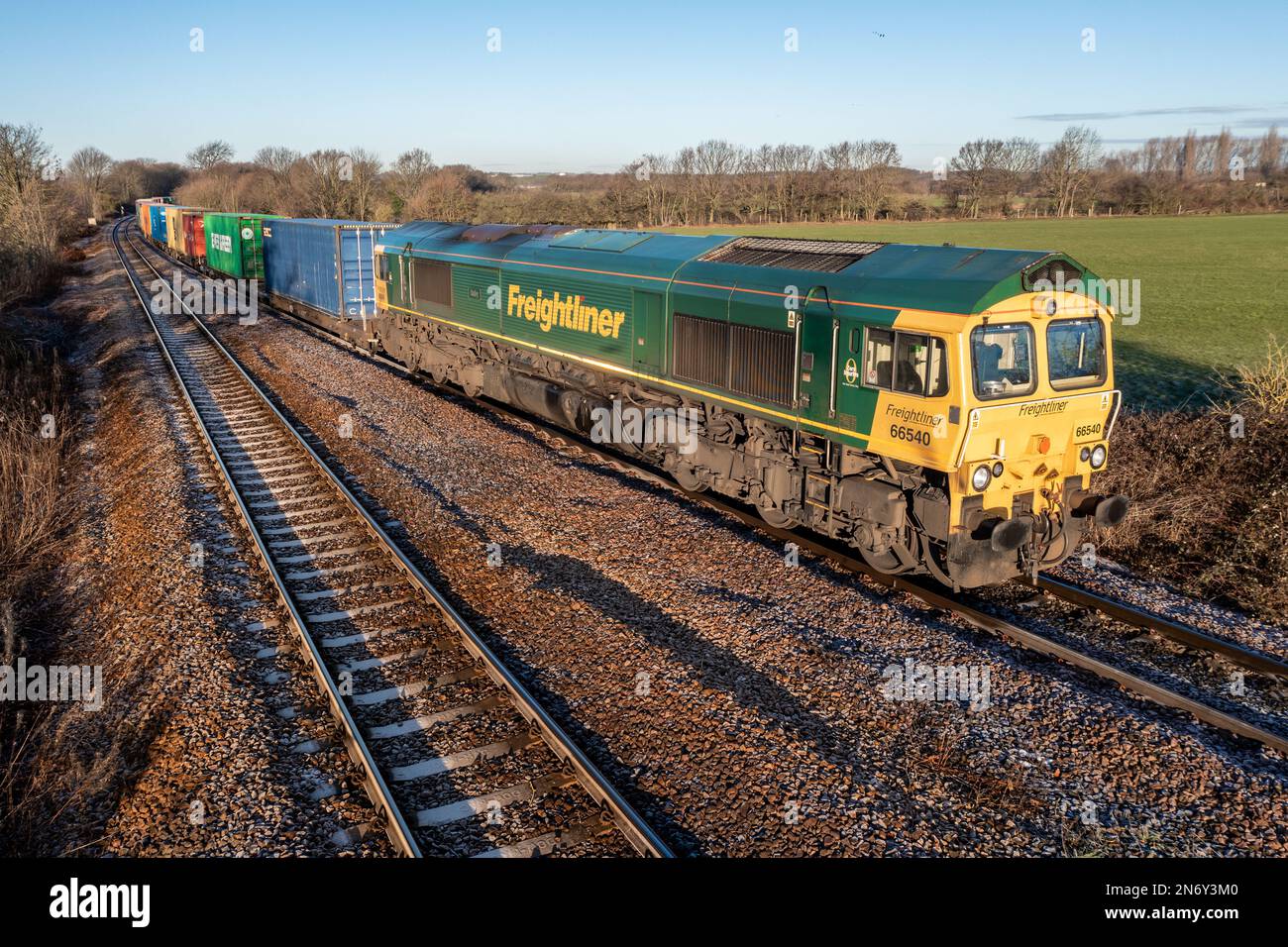 WAKEFIELD, UK - JANUARY 20, 2023.  A Freightliner Intermodal locomotive pulling a shipping container train between port and terminal in the UK Stock Photo