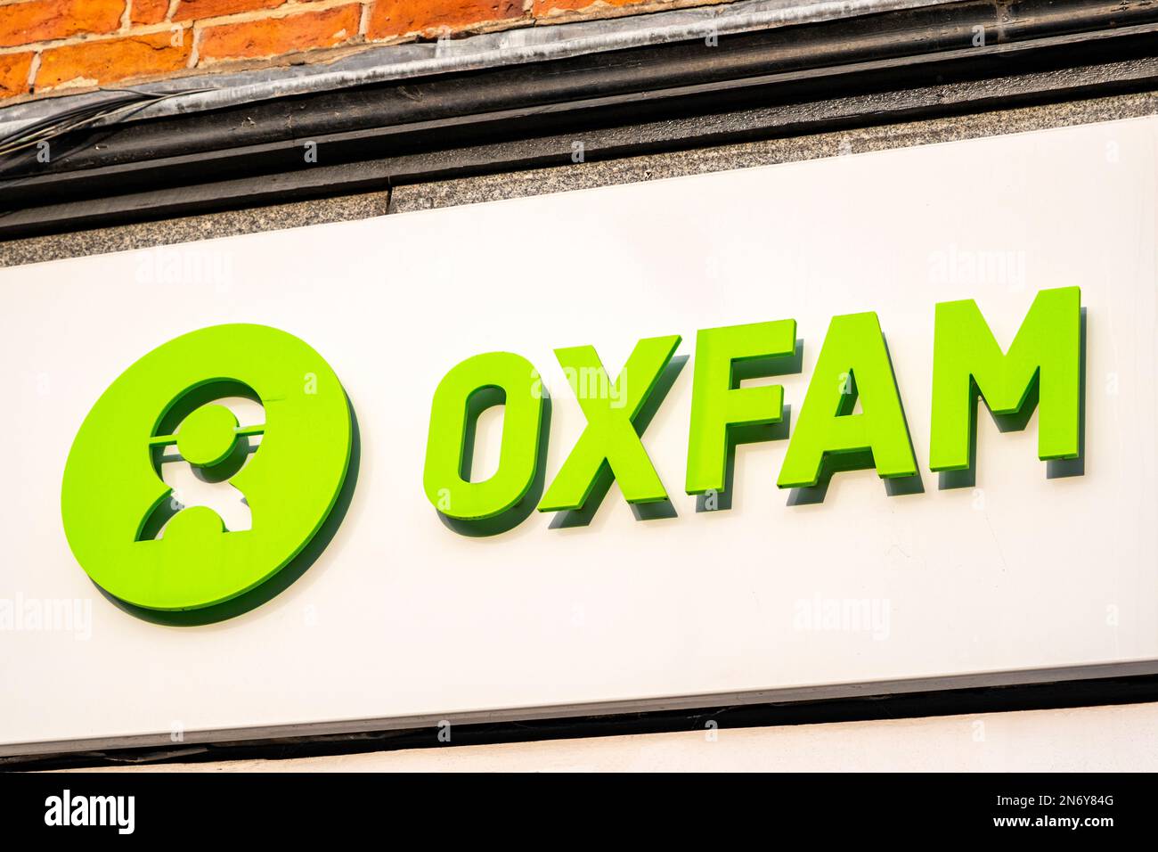 Close up of Oxfam charity shop sign on outside wall UK Stock Photo