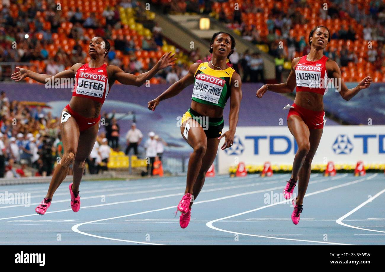 Jamaica's ShellyAnn FraserPryce, center, looks at the timing board