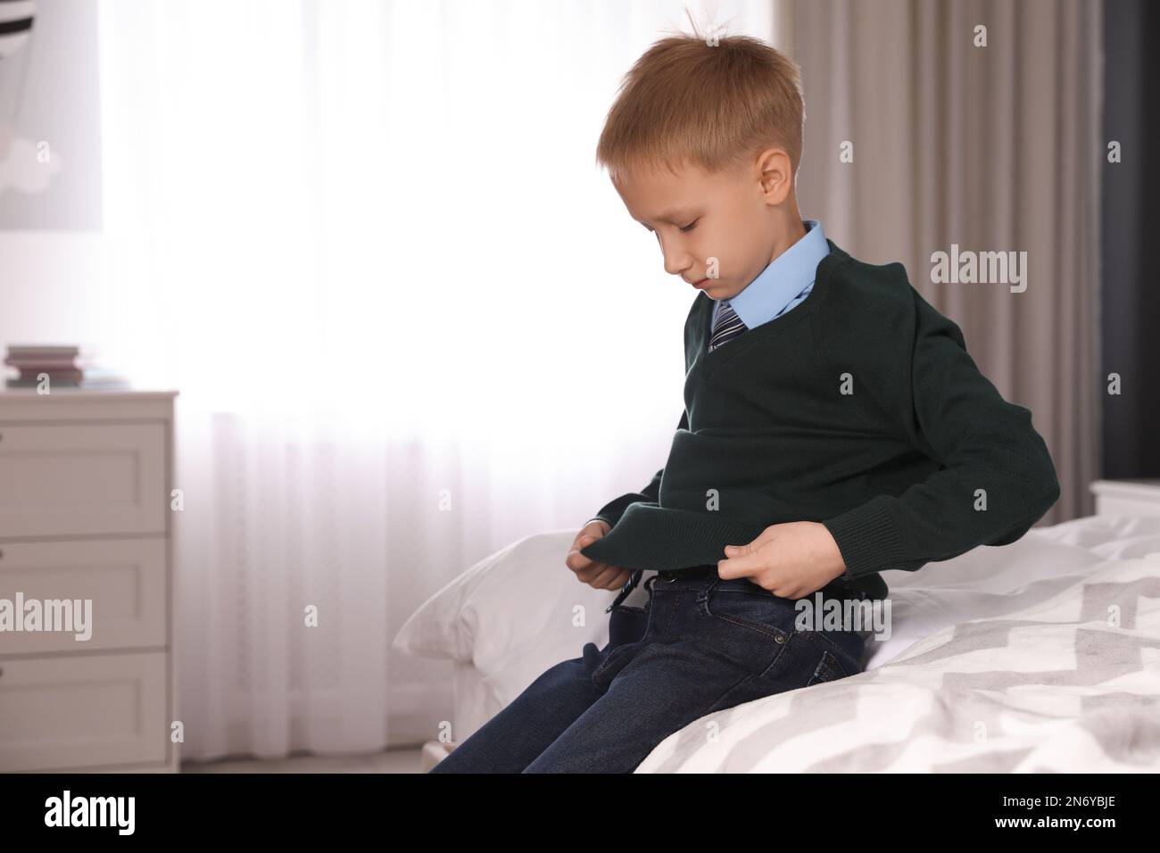 Little boy getting ready for school in bedroom Stock Photo - Alamy