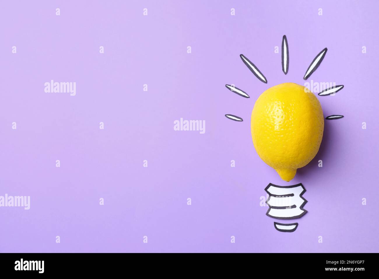 Composition with lemon as lamp bulb and space for text on violet background, top view. Creative concept Stock Photo