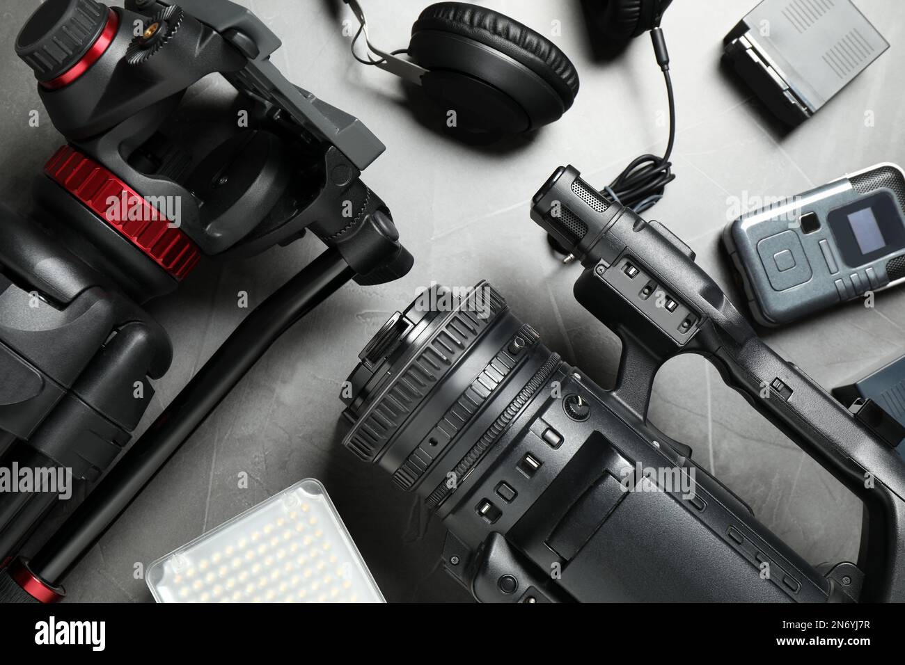 Flat lay composition with camera and video production equipment on grey ...