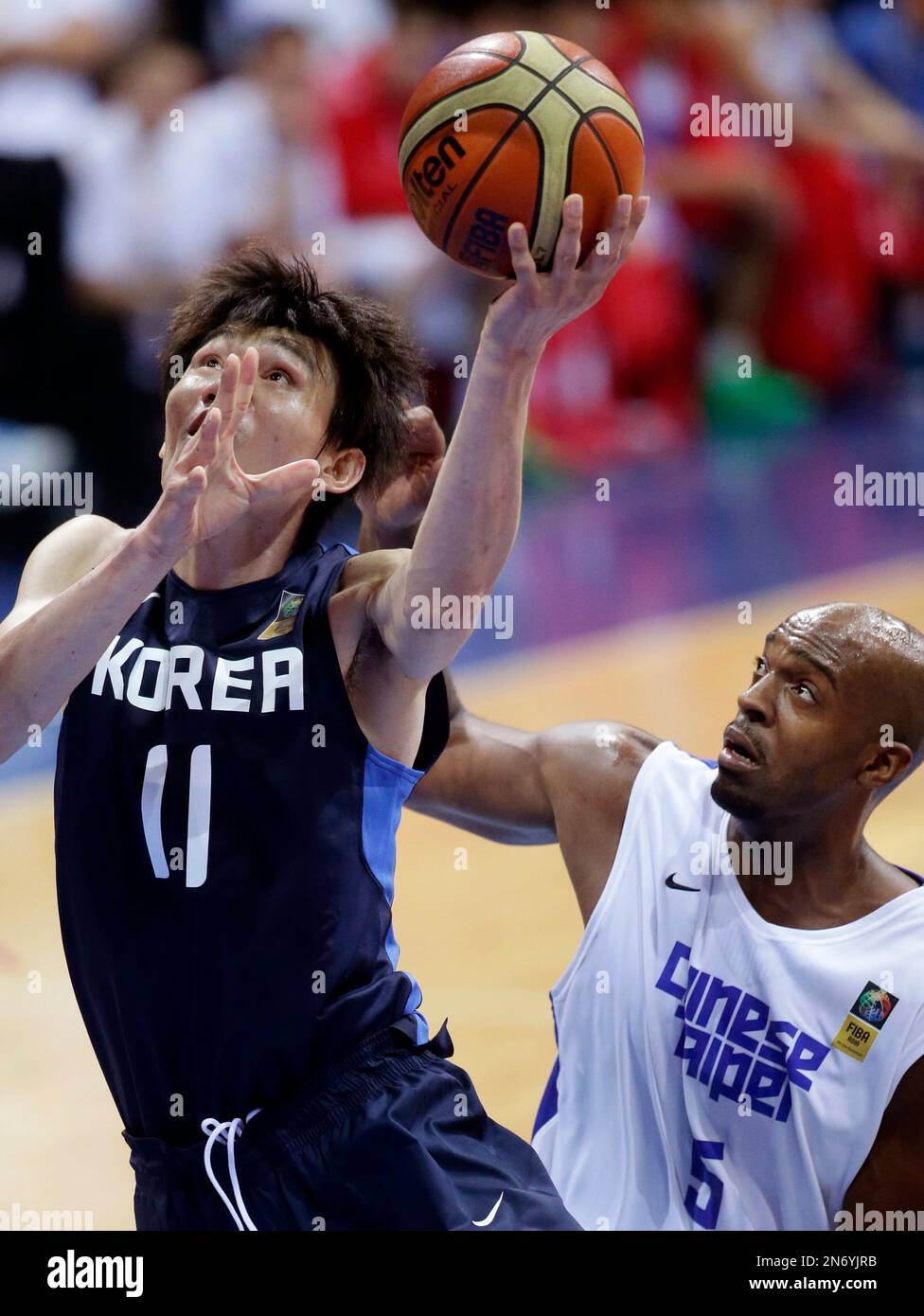 South Korea's Kim Joo-sung, left, is fouled by Taiwan's Tseng Wen