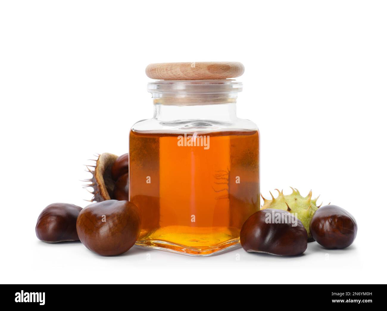 Horse chestnuts and bottle of tincture on white background Stock Photo
