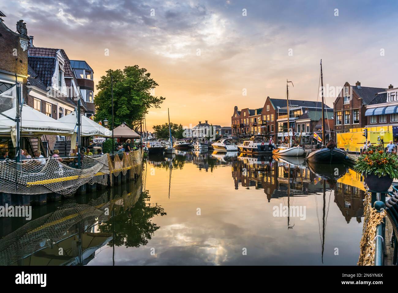 Lemmer, Netherlands - August 15, 2022: View of a water canal in the city of Lemmer in Friesland, Netherlands in beautiful sunset light Stock Photo